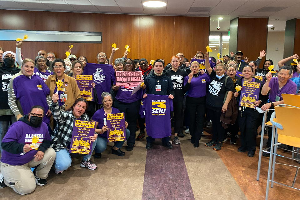 SEIU 1021 members rally before giving public comment at an AHS Board of Trustees meeting.