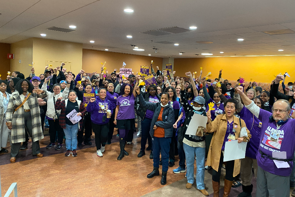 SEIU 1021 members rally before giving public comment at an AHS Board of Trustees meeting.