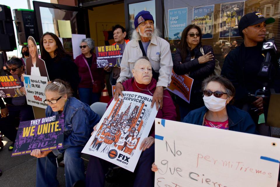 Clients of the South East Mission Geriatric Clinic rallied Wednesday outside the clinic to protest its impending closure.