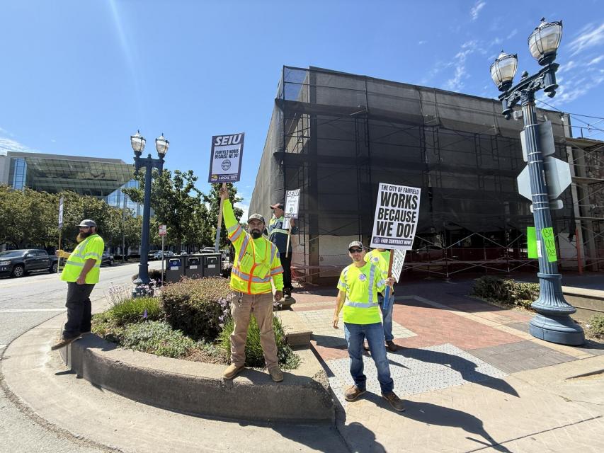 City of Fairfield workers standing on street corner downtown Fairfield holding signs for community engagement